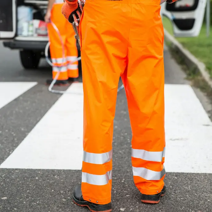 High-visibility orange work pants for petroleum field safety